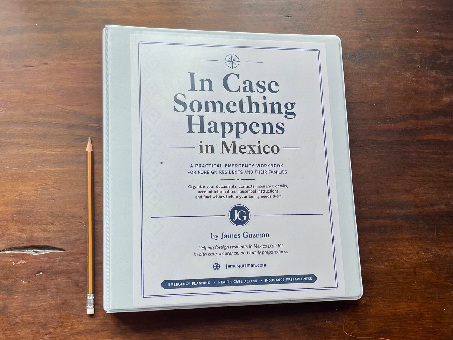 Front view of the printed workbook beside a pencil